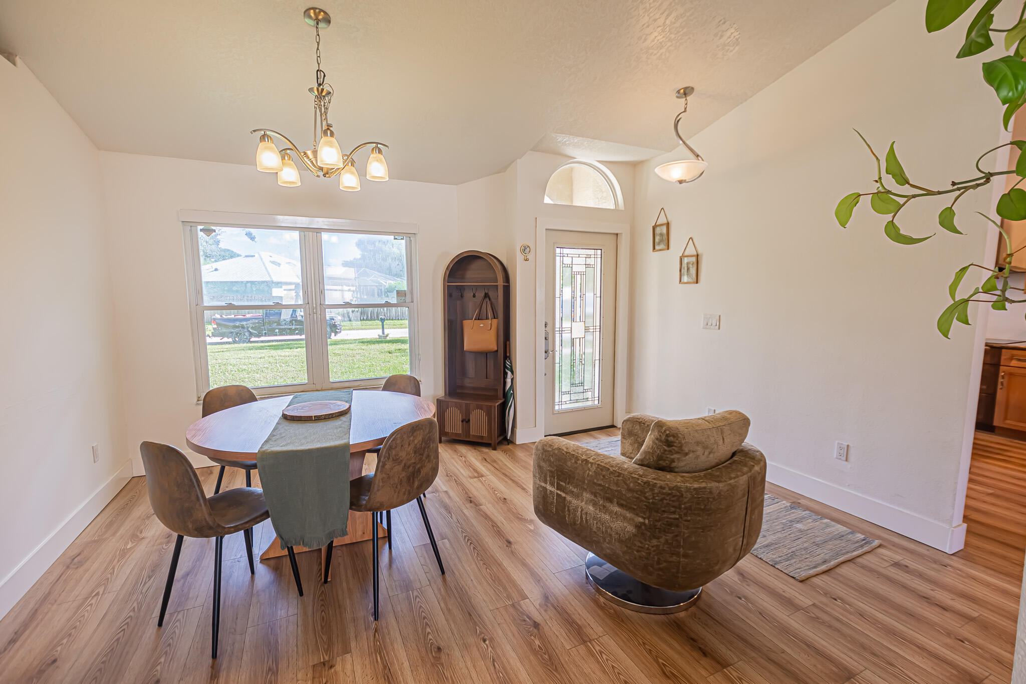 526 Southwest Dairy Road Port St. Lucie, FL 34953 - Photo 2 of 23 a living room with furniture and a chandelier