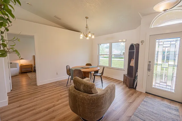 a dining room with furniture and wooden floor