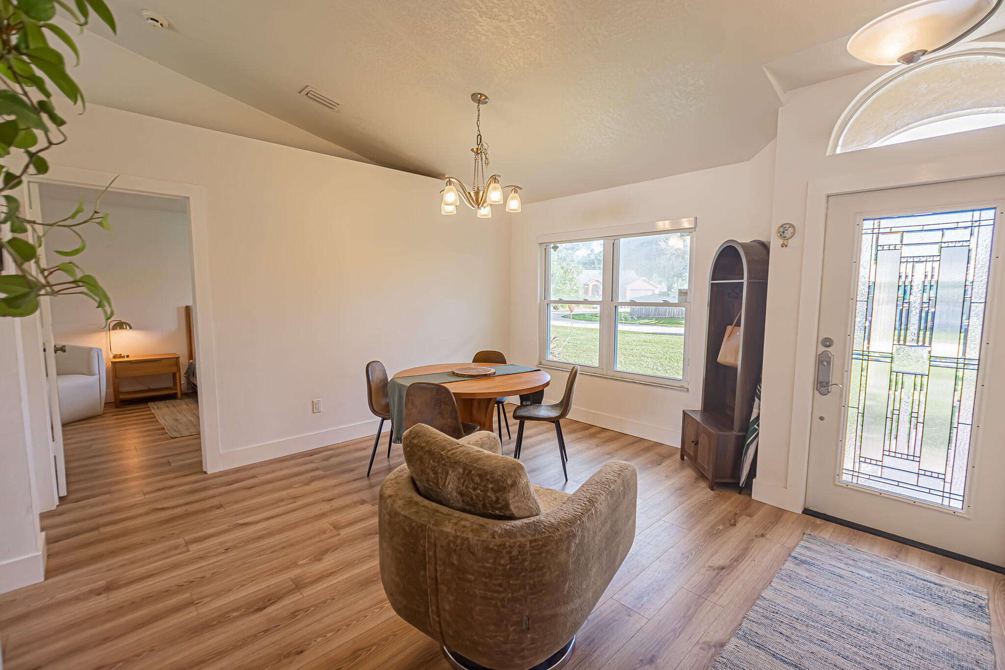 526 Southwest Dairy Road Port St. Lucie, FL 34953 - Photo 3 of 23 a dining room with furniture and wooden floor