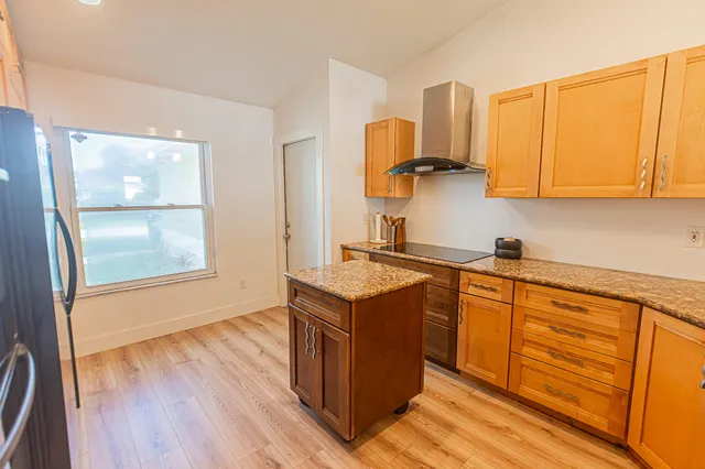 a kitchen with stainless steel appliances granite countertop a stove and a sink