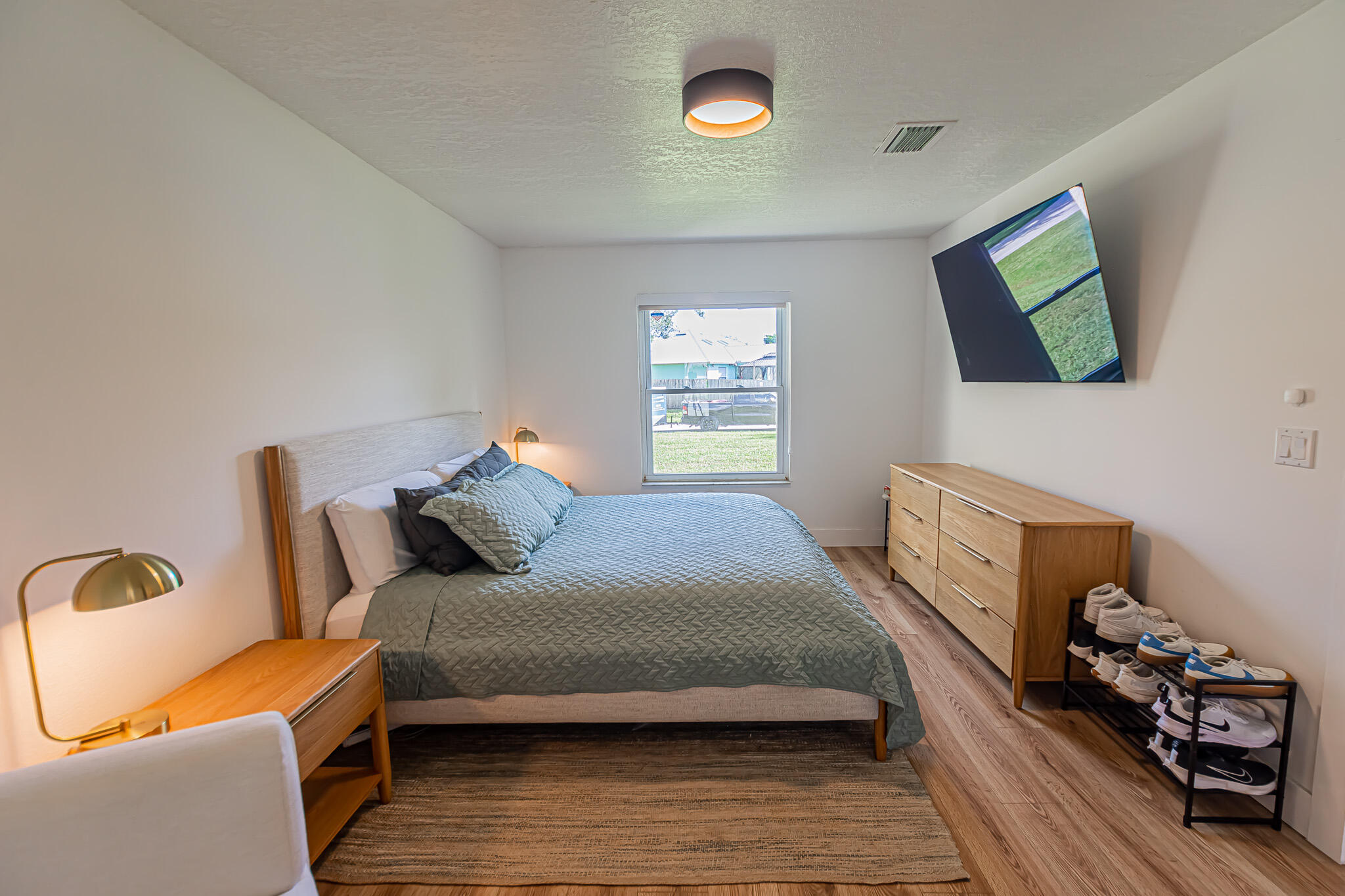 526 Southwest Dairy Road Port St. Lucie, FL 34953 - Photo 8 of 23 a bedroom with a bed and wooden floor