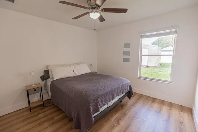a bedroom with a bed lamp and window