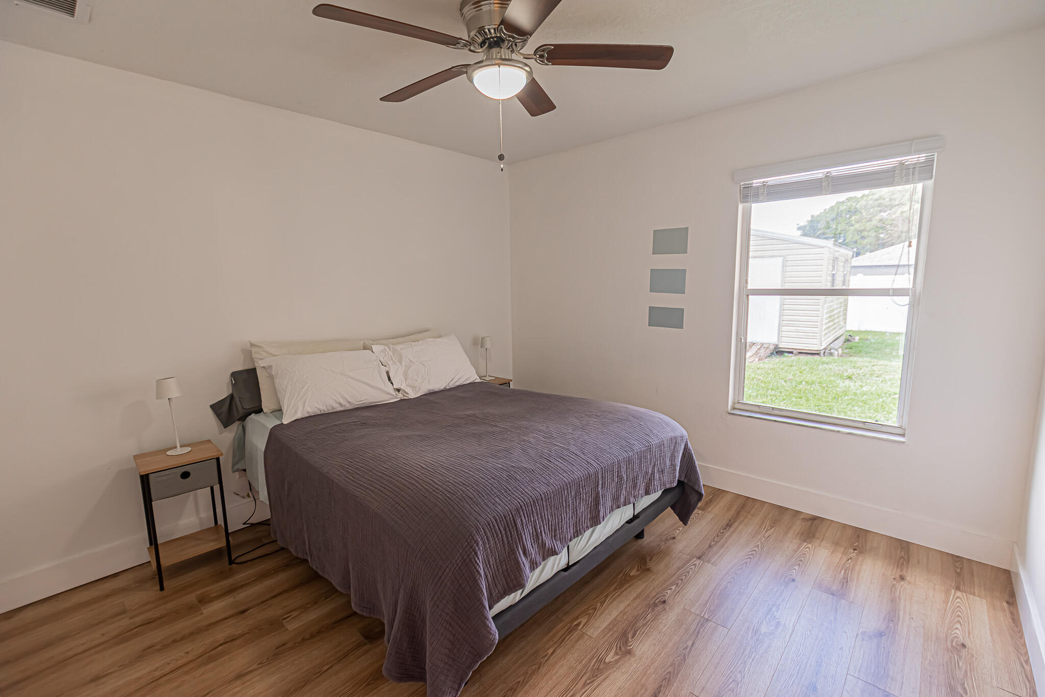 526 Southwest Dairy Road Port St. Lucie, FL 34953 - Photo 10 of 23 a bedroom with a bed lamp and window