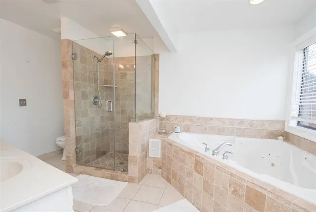 a bathroom with a bathtub and a shower