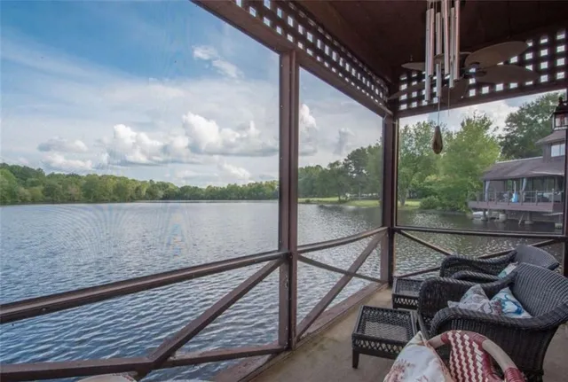 a view of a balcony with chairs and wooden floor