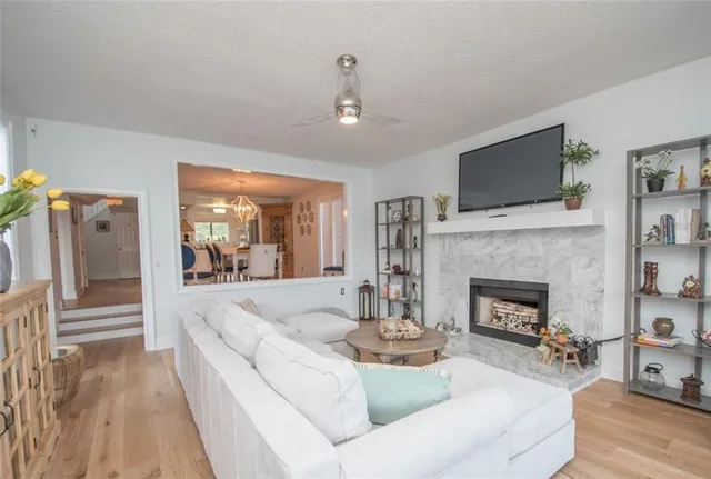 a living room with furniture a fireplace and a flat screen tv