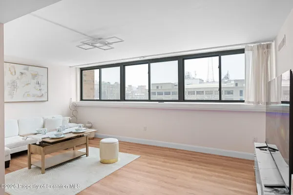 a room with furniture wooden floor and a window