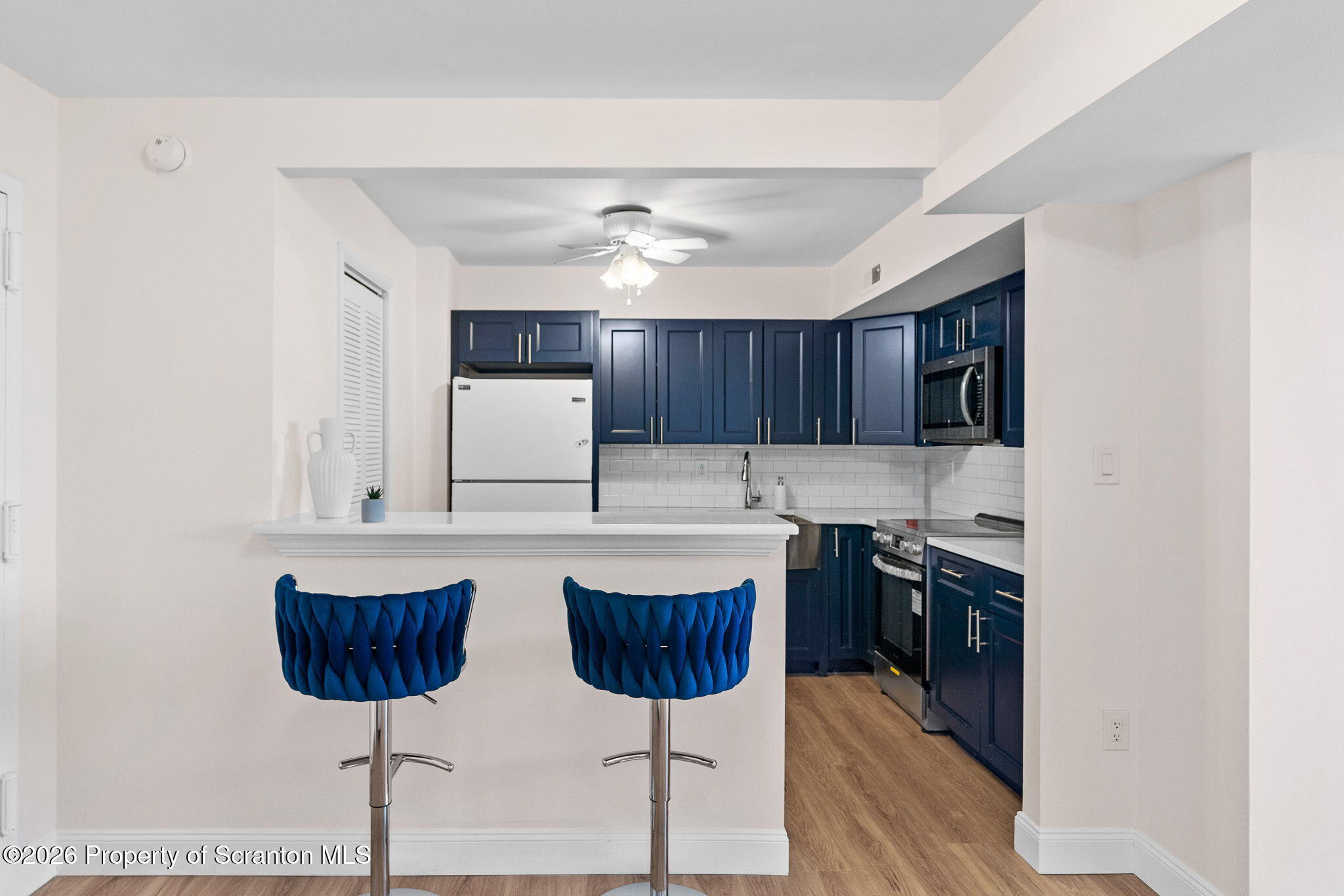 220 Linden Street, Unit 503 Scranton, PA 18503 - Photo 12 of 40 a kitchen with stainless steel appliances a stove a sink and a refrigerator