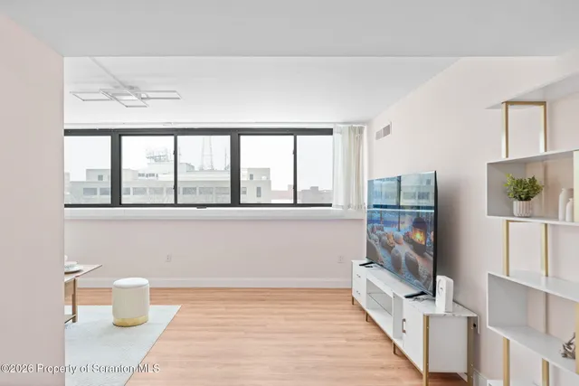 a living room with furniture and a large window