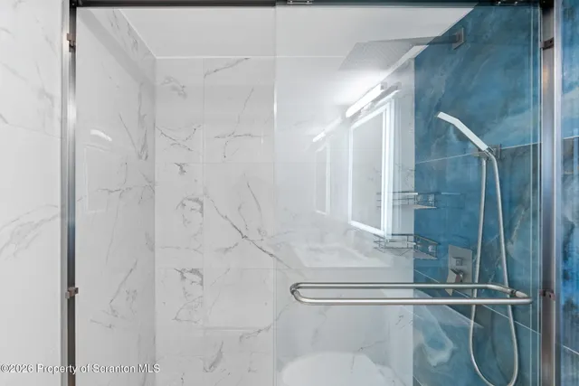 a hallway with white cabinets and window