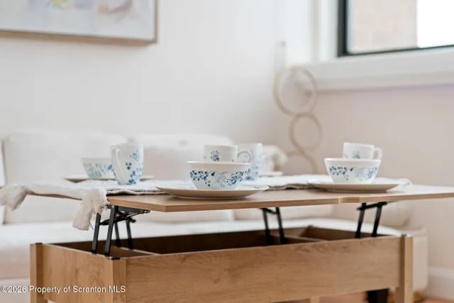 a room with a table chairs and entryway