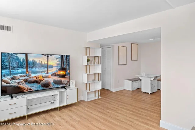 a open hall with furniture and wooden floor