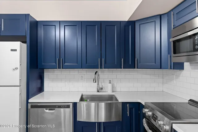 a kitchen with a sink and a refrigerator