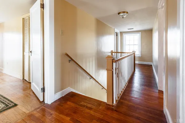 a bedroom with furniture and wooden floor
