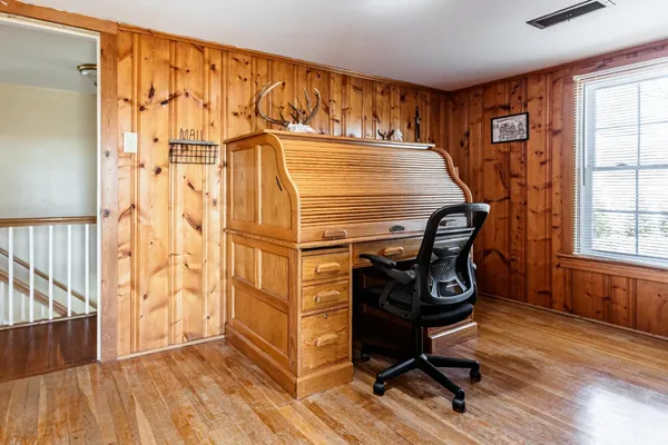 a room with wooden floor and a window