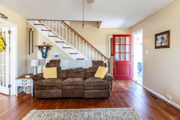 a living room with furniture and wooden floor