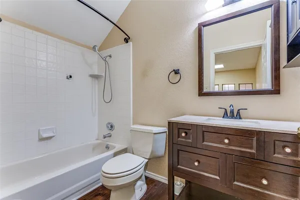 a bathroom with a bathtub toilet sink vanity and mirror