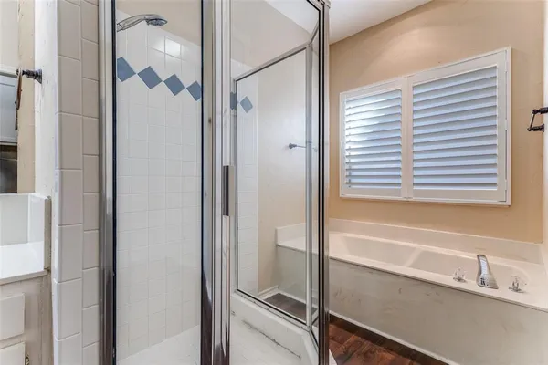 a bathroom with a bathtub and a shower