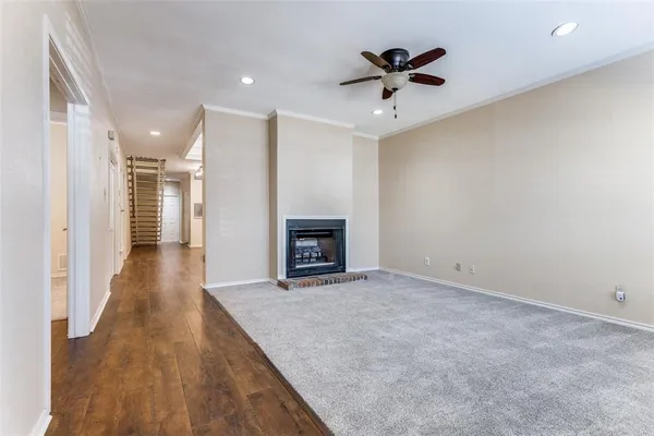 wooden floor in an empty room with a ceiling fan