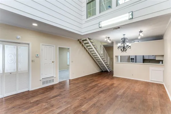 a view of a hallway with wooden floor and staircase