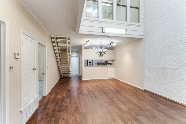 a view of a kitchen with wooden floor and cabinets