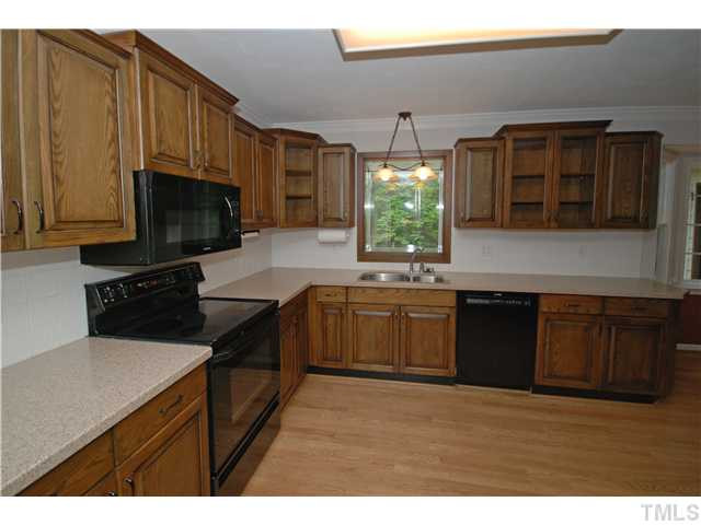 8304 Heel Stone Court Raleigh, NC 27613 - Photo 4 of 25 The kitchen also features a built-in wine rack and several glass front display cabinets. Kitchen