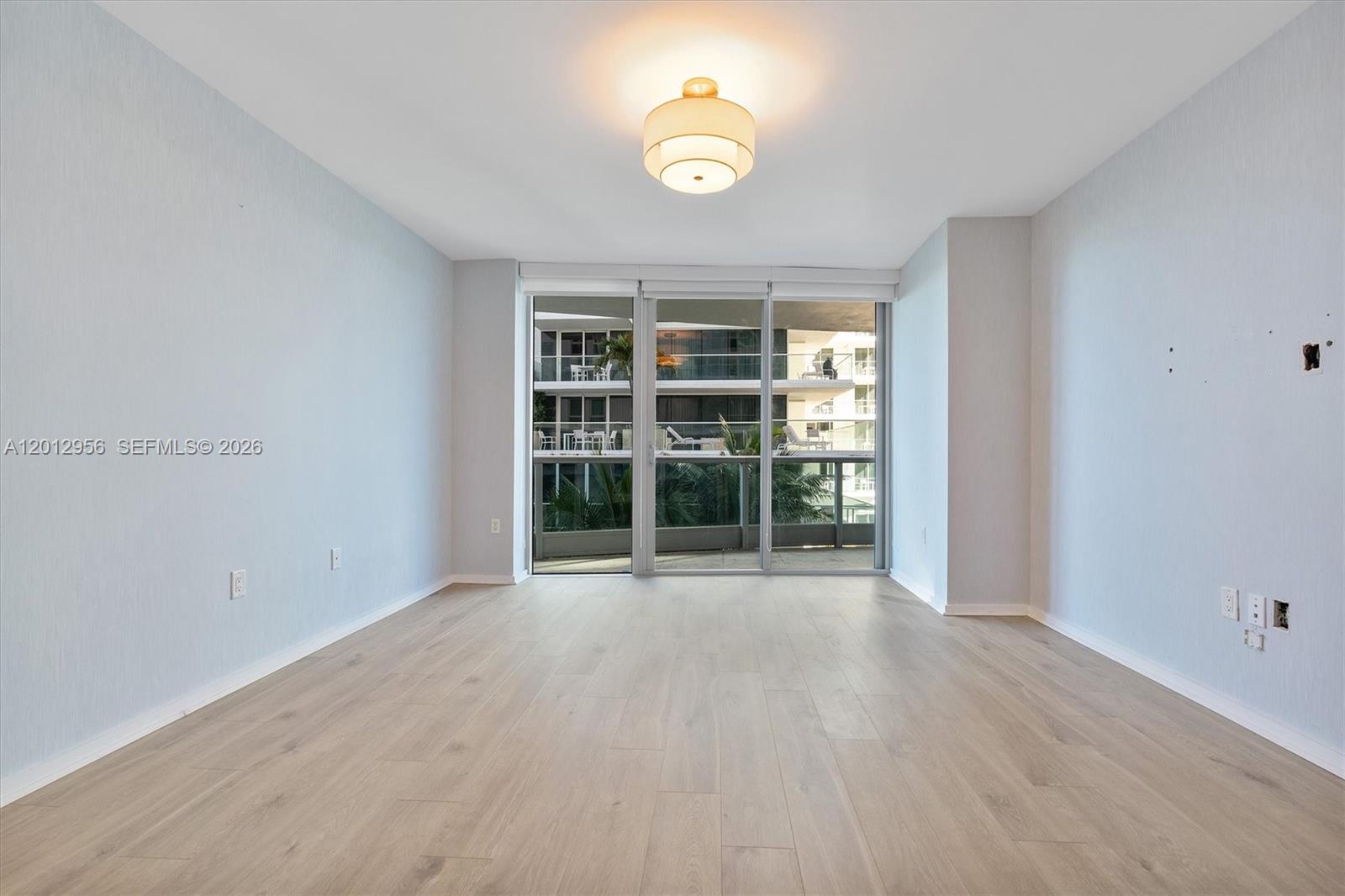 9401 Collins Avenue, Unit 505 Surfside, FL 33154 - Photo 15 of 39 wooden floor in an empty room with a window