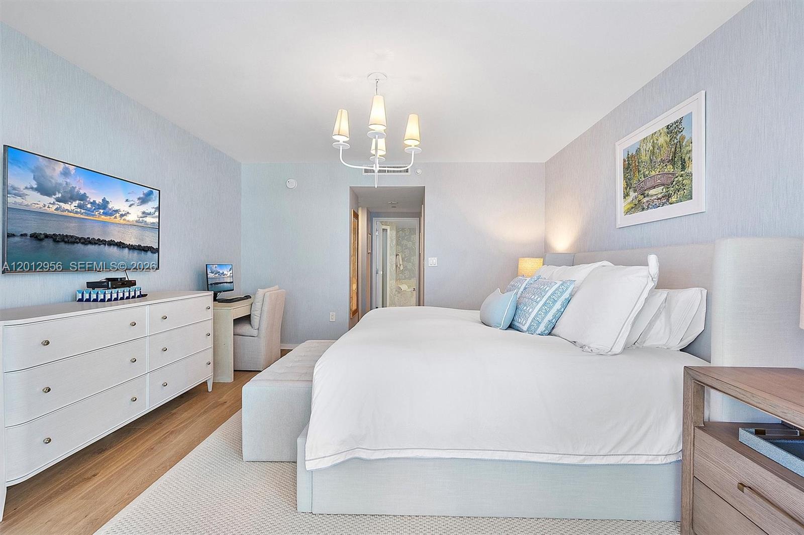 9401 Collins Avenue, Unit 505 Surfside, FL 33154 - Photo 17 of 39 a bedroom with a large bed and a chandelier