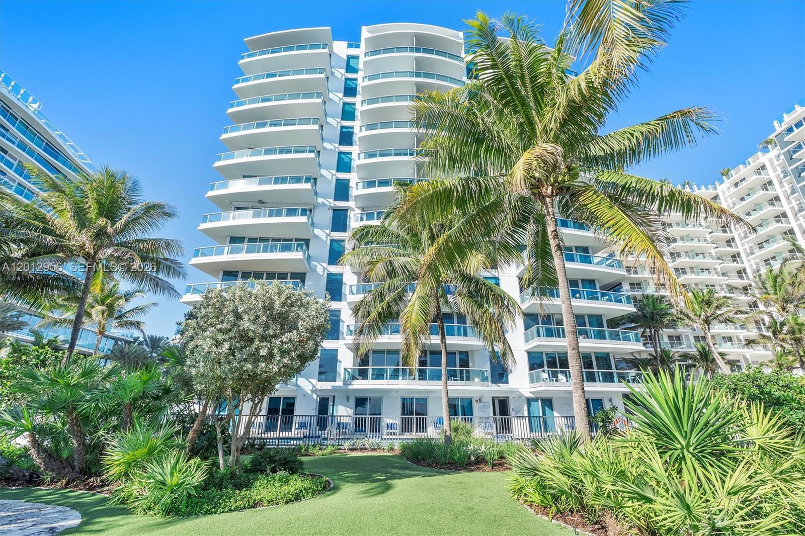 9401 Collins Avenue, Unit 505 Surfside, FL 33154 - Photo 2 of 39 a front view of a multi story building with yard