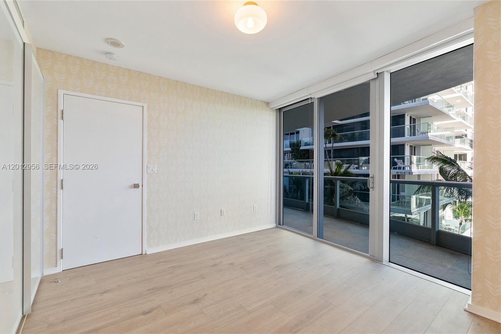 9401 Collins Avenue, Unit 505 Surfside, FL 33154 - Photo 23 of 39 an empty room with furniture and a window