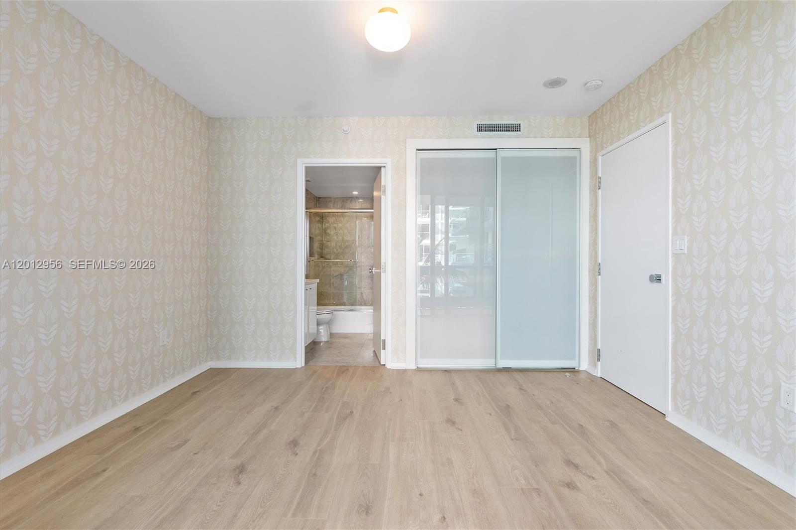 9401 Collins Avenue, Unit 505 Surfside, FL 33154 - Photo 24 of 39 wooden floor in an empty room