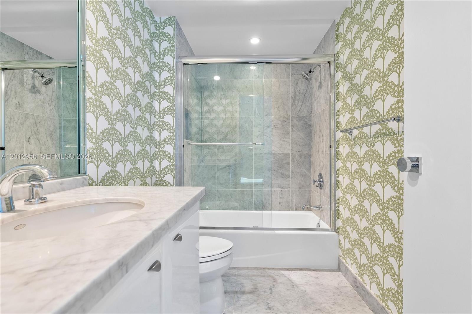 9401 Collins Avenue, Unit 505 Surfside, FL 33154 - Photo 25 of 39 a bathroom with a sink a toilet and shower