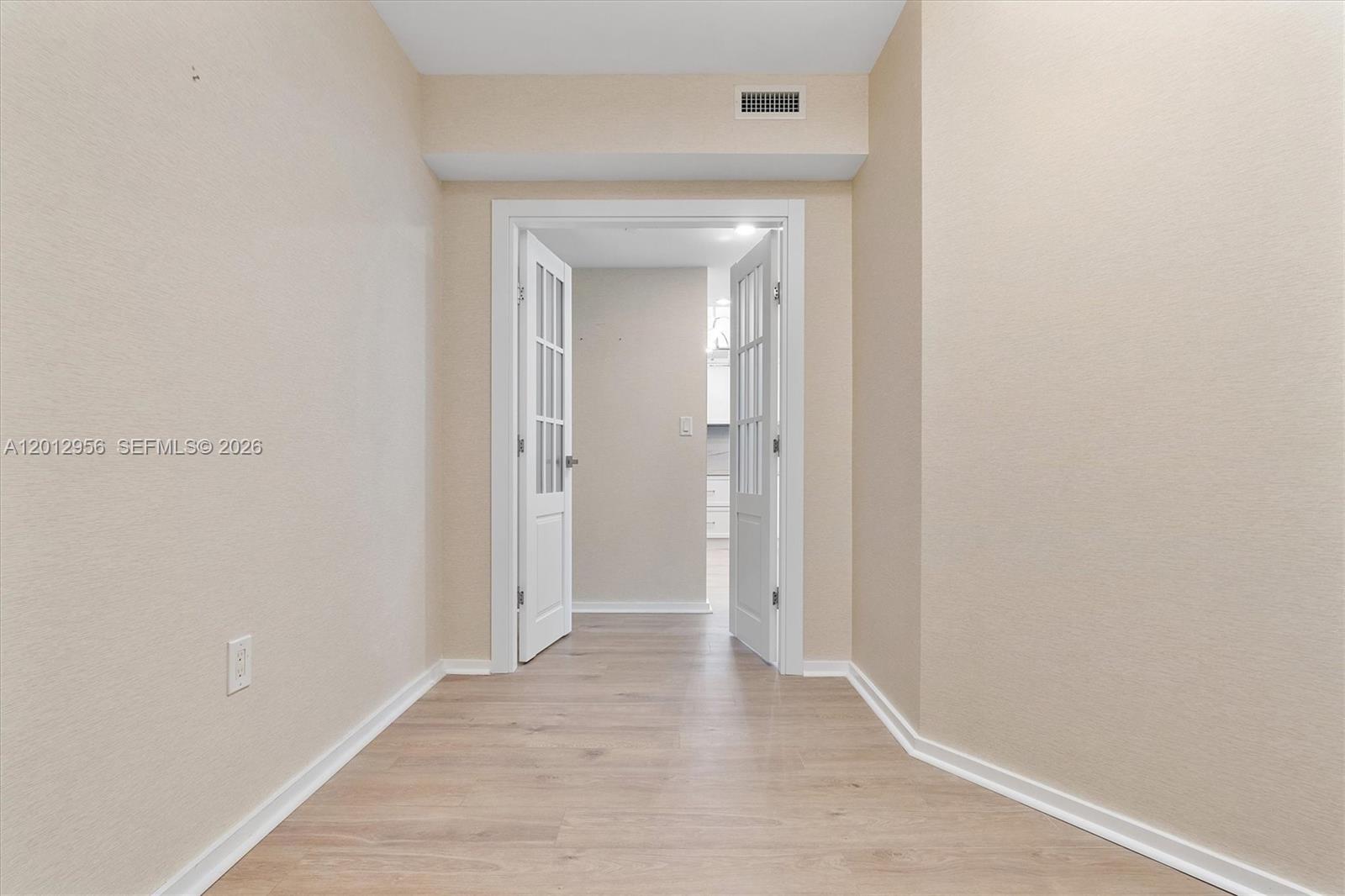 9401 Collins Avenue, Unit 505 Surfside, FL 33154 - Photo 28 of 39 a view of a hallway with wooden floor