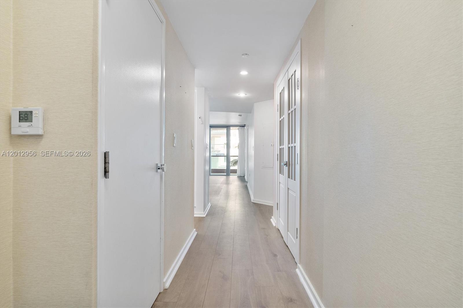 9401 Collins Avenue, Unit 505 Surfside, FL 33154 - Photo 3 of 39 a view of a hallway with wooden floor