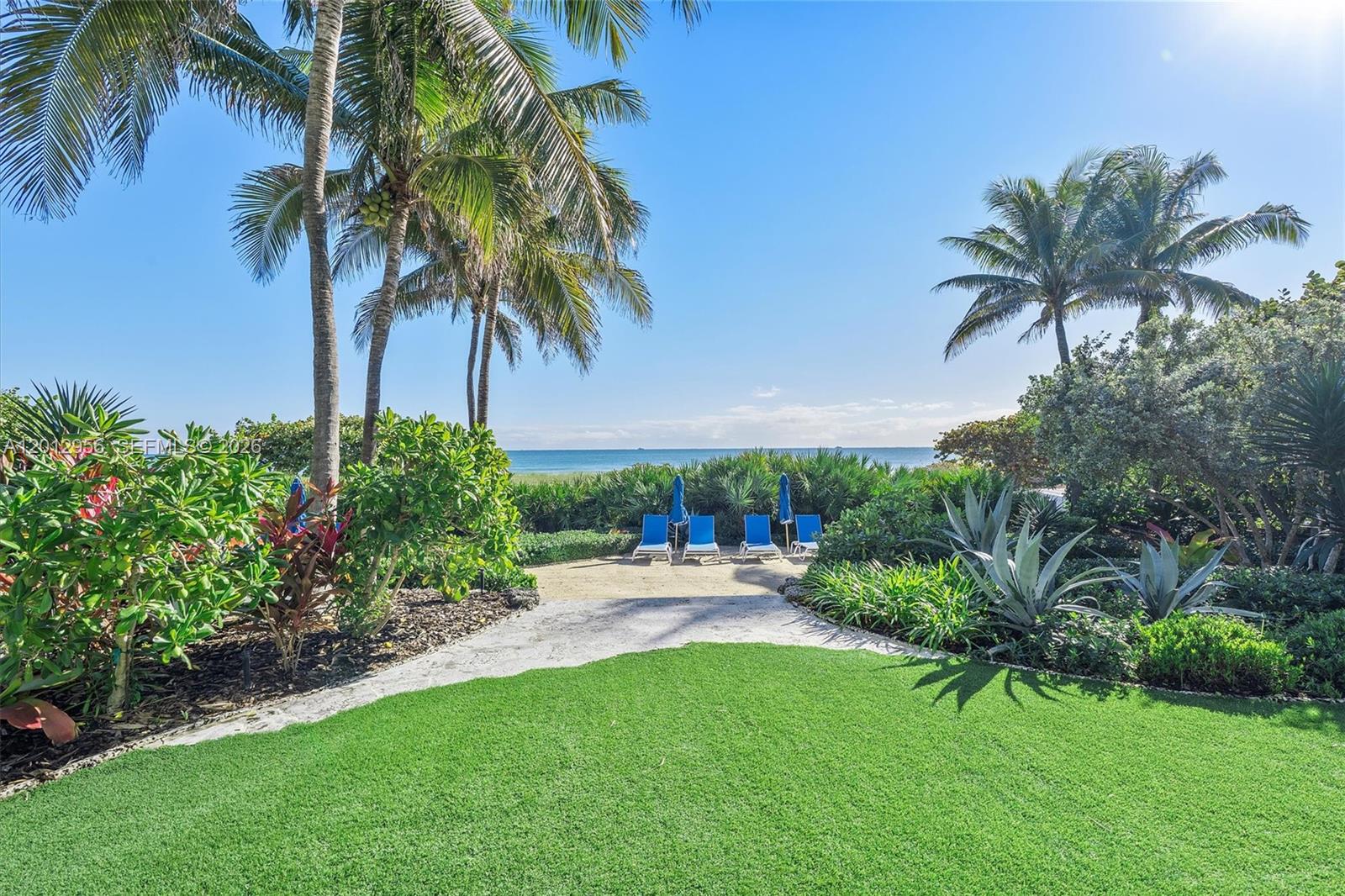 9401 Collins Avenue, Unit 505 Surfside, FL 33154 - Photo 37 of 39 a couple of palm trees sitting in a yard with swimming pool
