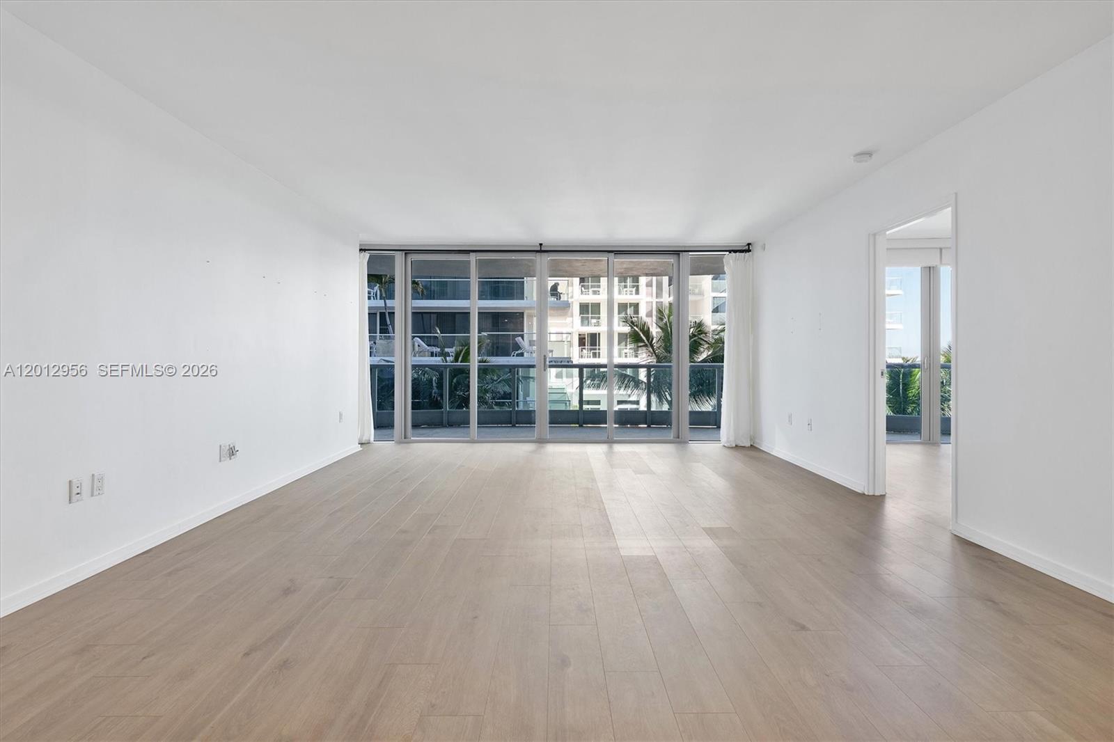 9401 Collins Avenue, Unit 505 Surfside, FL 33154 - Photo 4 of 39 wooden floor in an empty room with a window