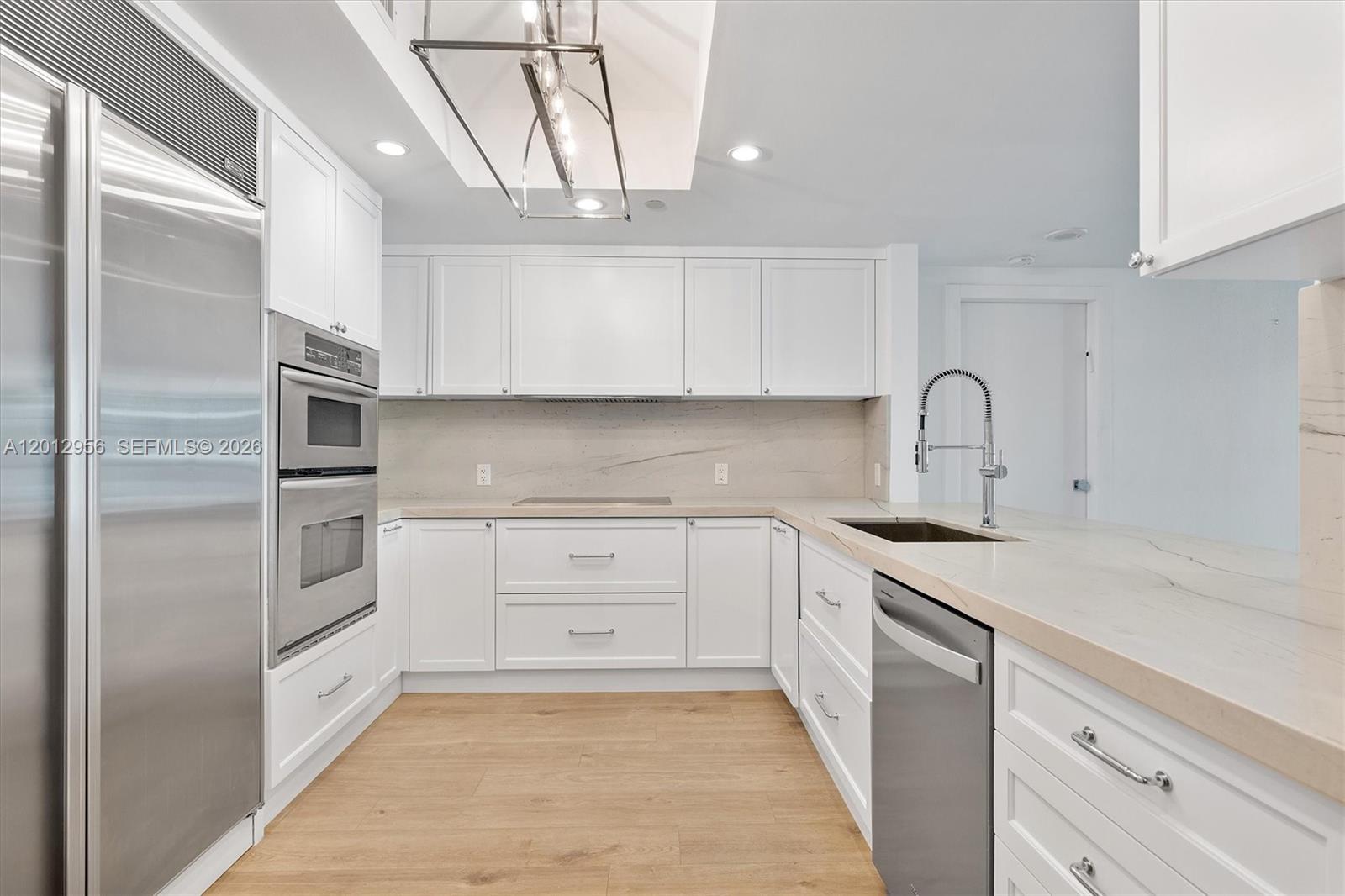 9401 Collins Avenue, Unit 505 Surfside, FL 33154 - Photo 8 of 39 a kitchen with a refrigerator sink and cabinets