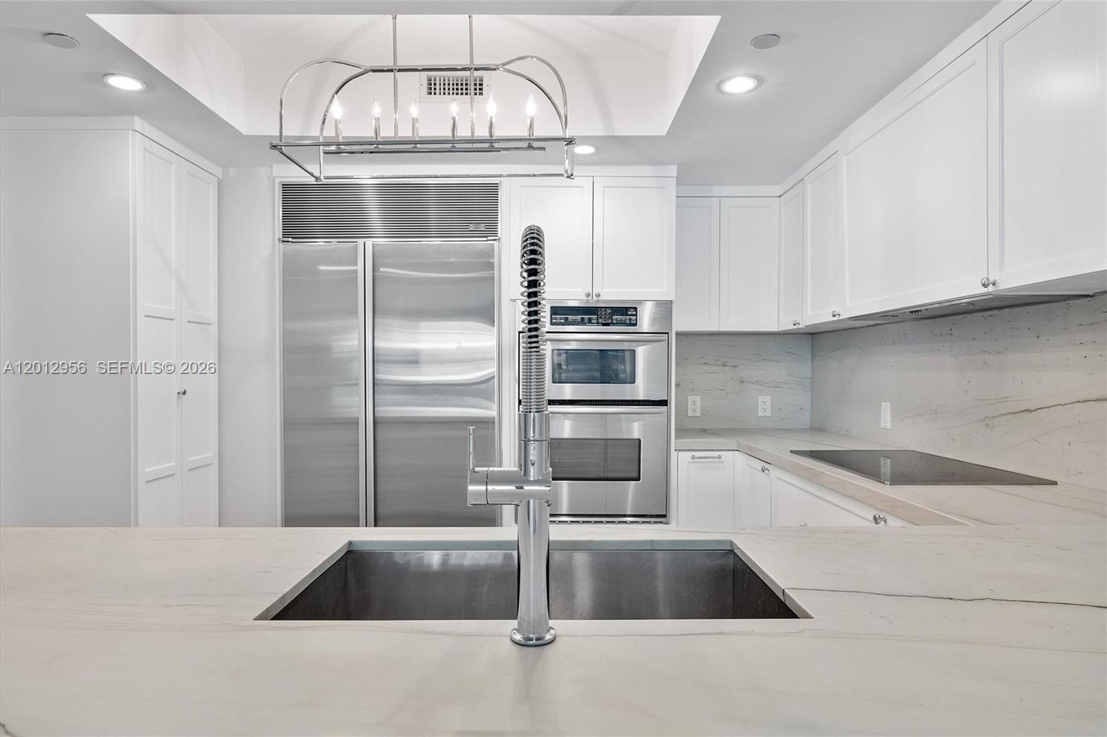 9401 Collins Avenue, Unit 505 Surfside, FL 33154 - Photo 10 of 39 a kitchen with a sink and refrigerator