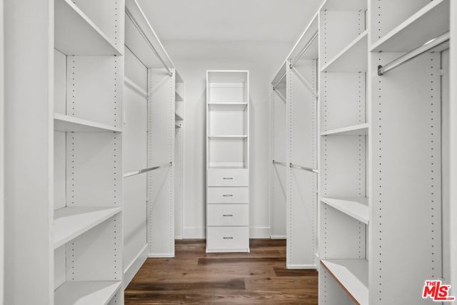a view of walk in closet with white walls