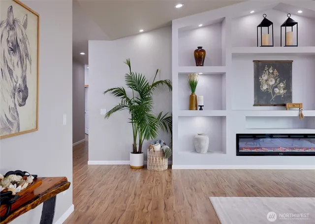 a living room with furniture and a potted plant
