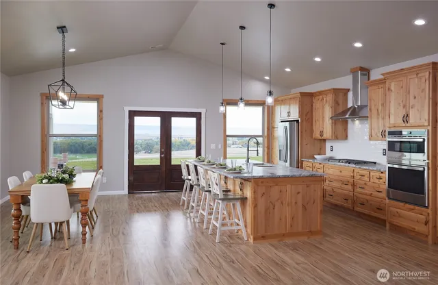 a large kitchen with a table and chairs