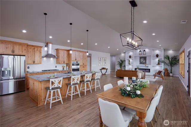 a large kitchen with a table and chairs