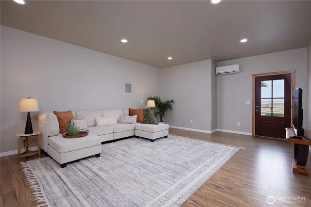 a living room with furniture and wooden floor