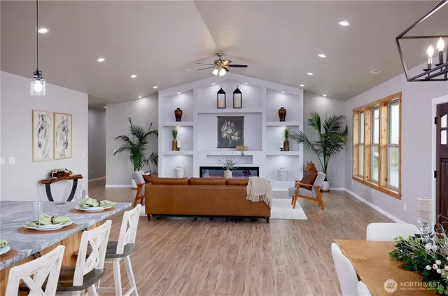 a living room with fireplace furniture and a chandelier