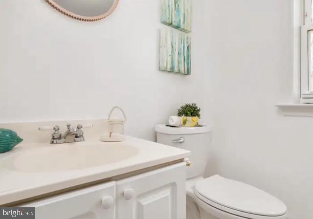 6432 West Shady Side Road Shady Side, MD 20764 - Photo 12 of 13 a bathroom with a sink a toilet and a mirror