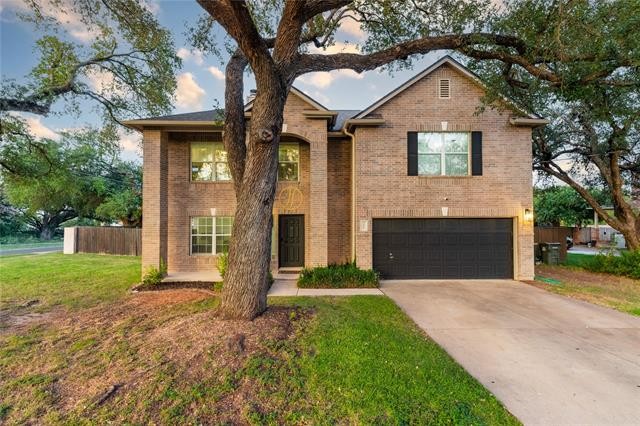 201 South Sumac Lane Georgetown, TX 78633 - Photo 2 of 15 View of front facade featuring brick siding, concrete driveway, and a garage