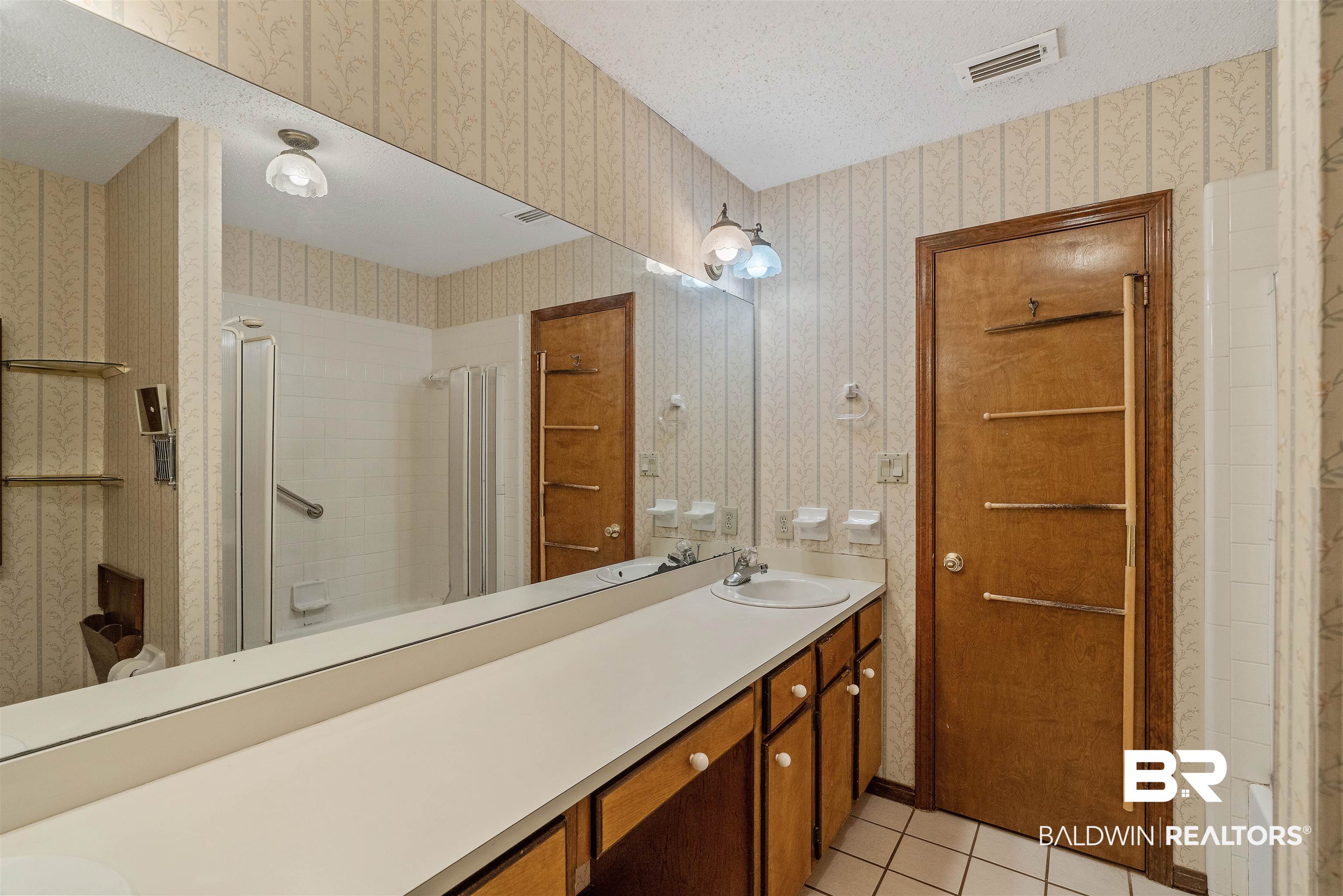 438 Ridgewood Drive Daphne, AL 36526 - Photo 14 of 28 Bathroom featuring tile patterned floors, a shower with shower door, vanity, and a textured ceiling