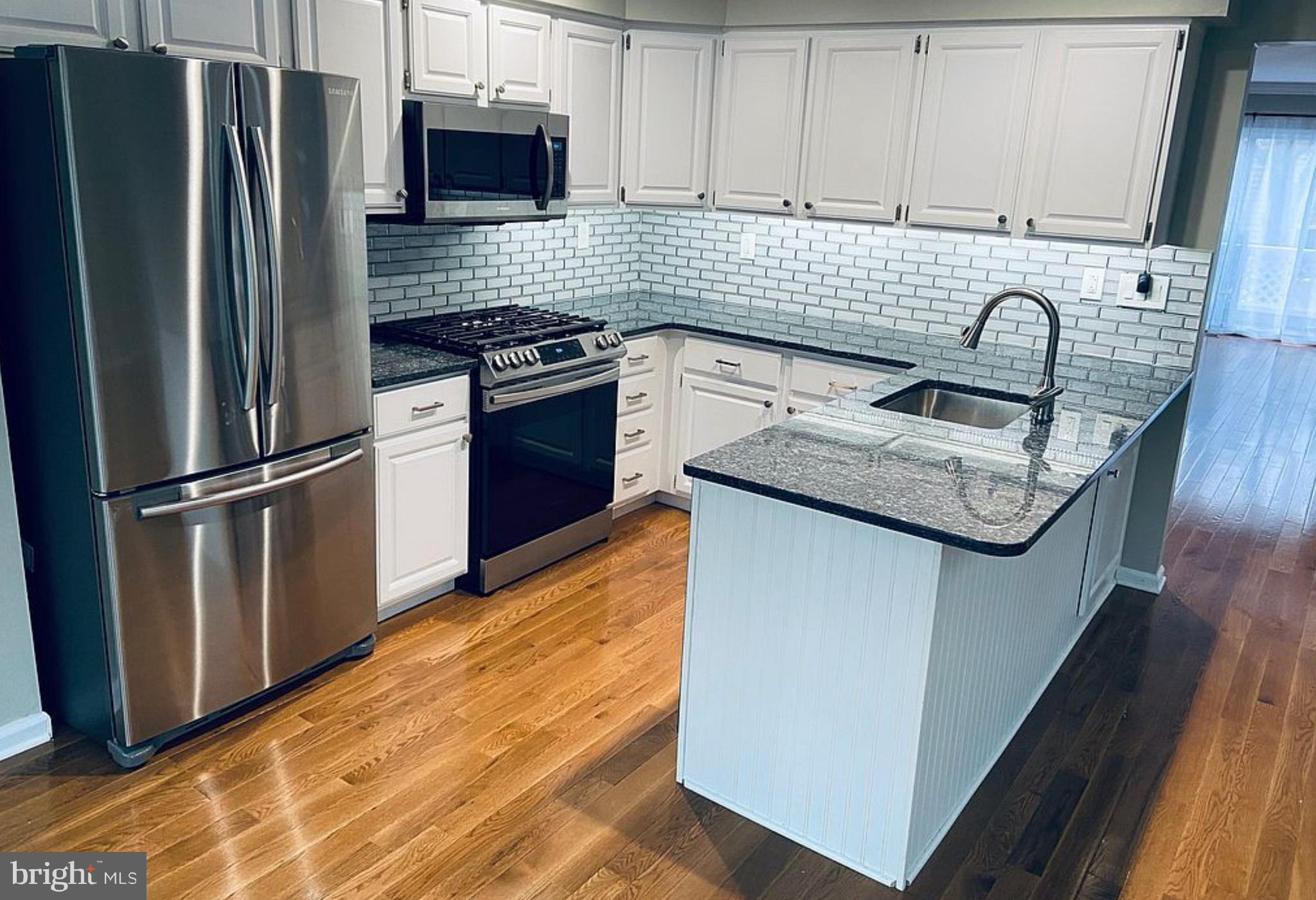 52 Cabot Drive Chesterbrook, PA 19087 - Photo 6 of 15 a kitchen with stainless steel appliances granite countertop a sink stove and refrigerator