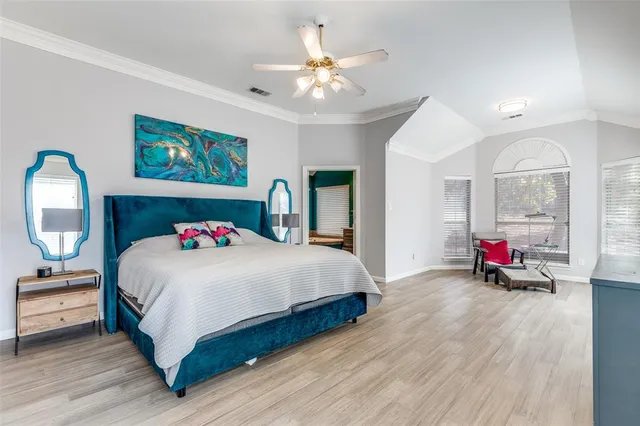 a bedroom with bed and a chandelier