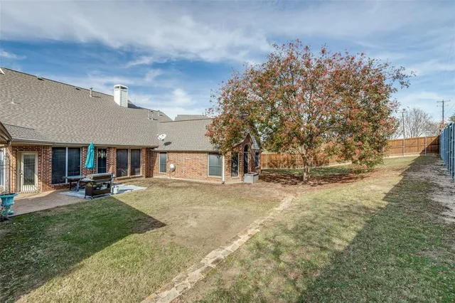 a view of a house with backyard and sitting area